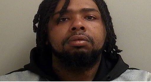 Mug Shot of Terrence Lamar Campbell. Black male with beard and mustache. Shoulder length hair in braids.